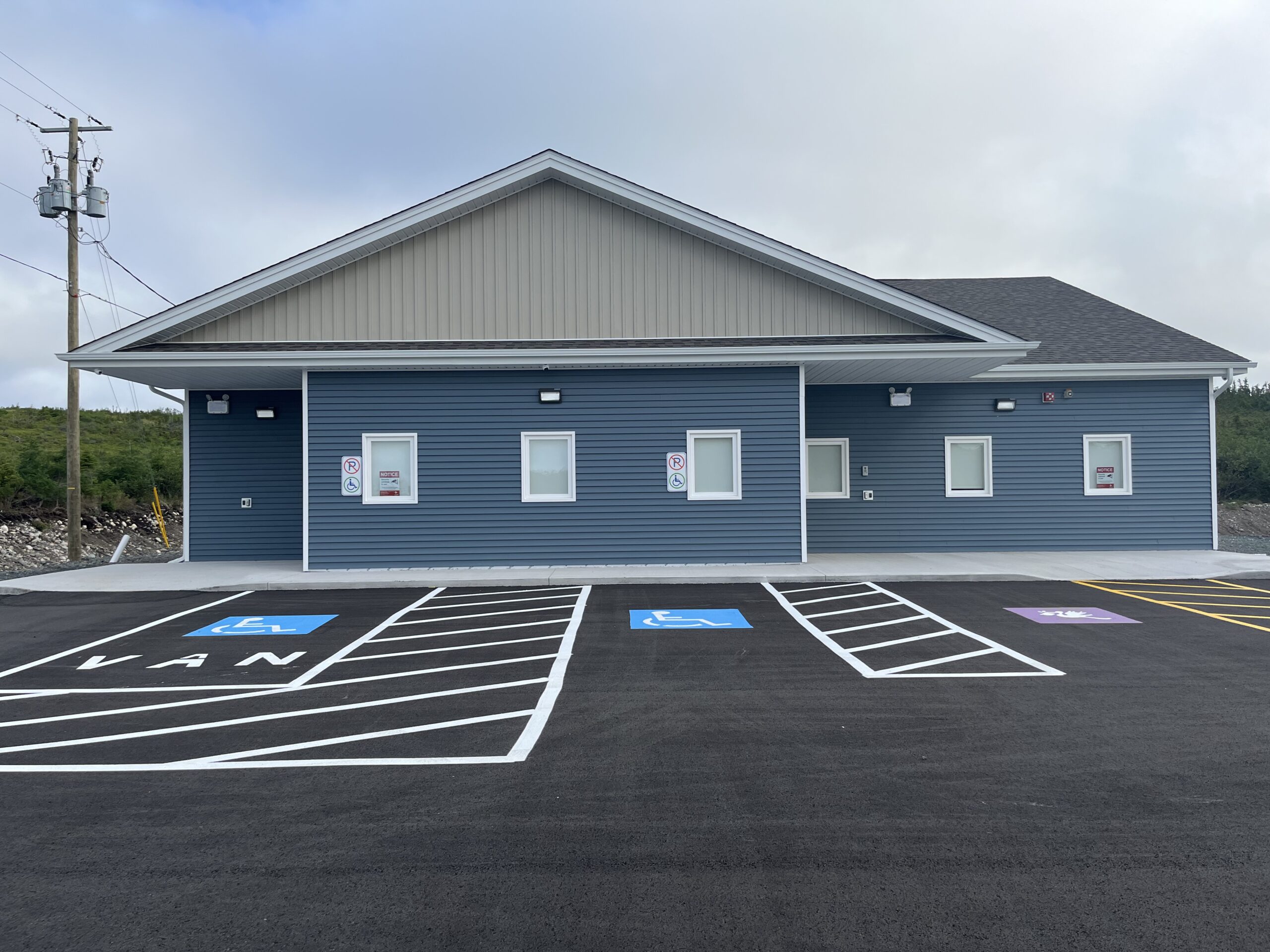Picture of the front of Community Services Arnold's Cover building and some parking places.